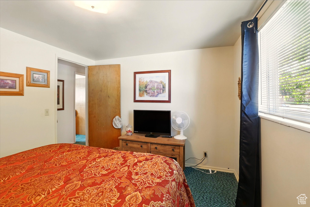 Bedroom with carpet floors and baseboards