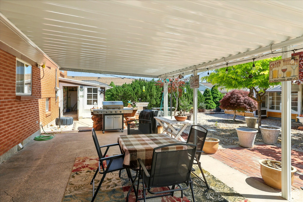View of patio / terrace featuring outdoor dining space and a grill