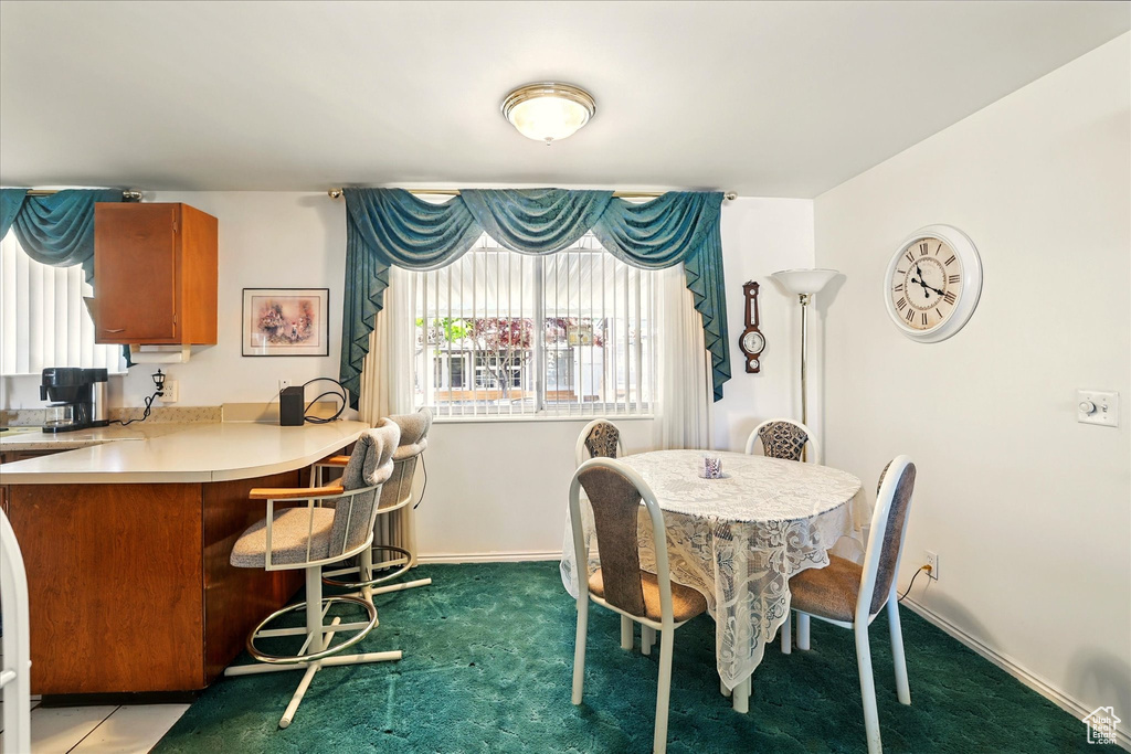 Dining room featuring carpet flooring and baseboards