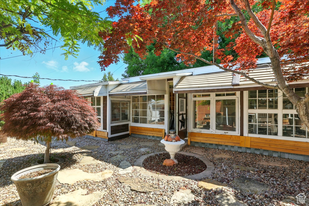 Rear view of house featuring a sunroom