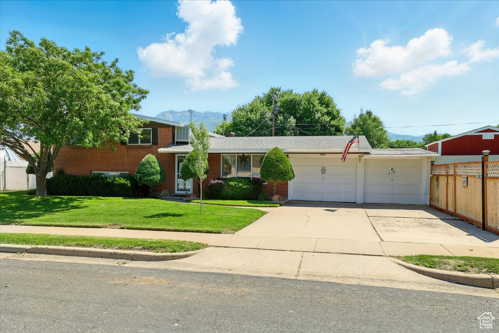 View of front of house featuring brick siding and a mountain view