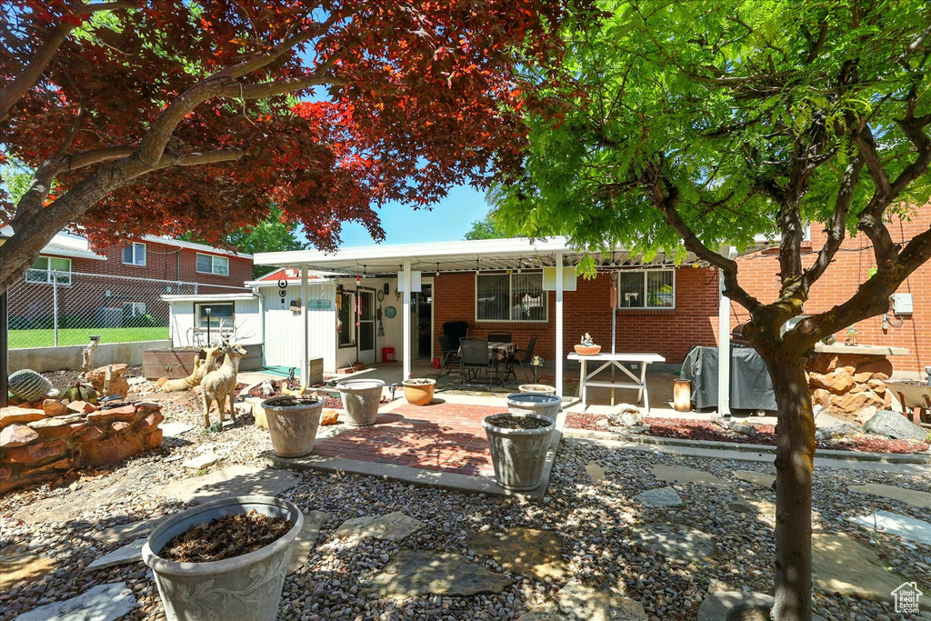 Back of house featuring a patio area and brick siding