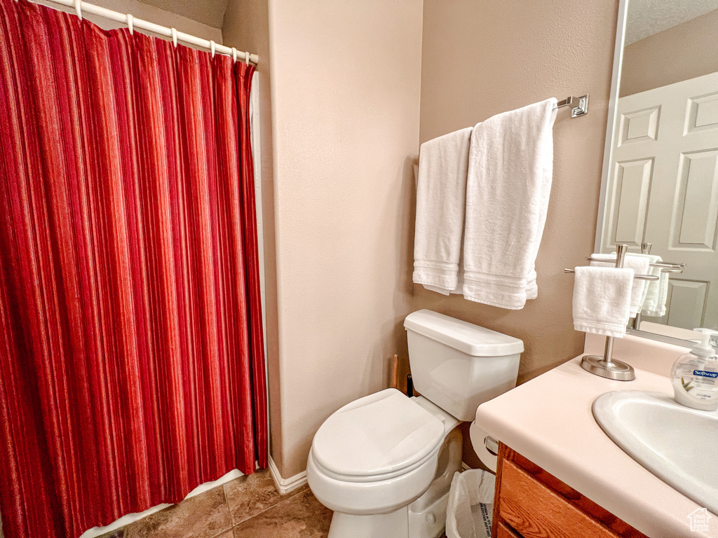 Full bath with vanity, toilet, tile patterned flooring, and a shower with shower curtain