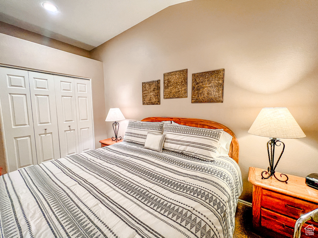 Bedroom with a closet and vaulted ceiling