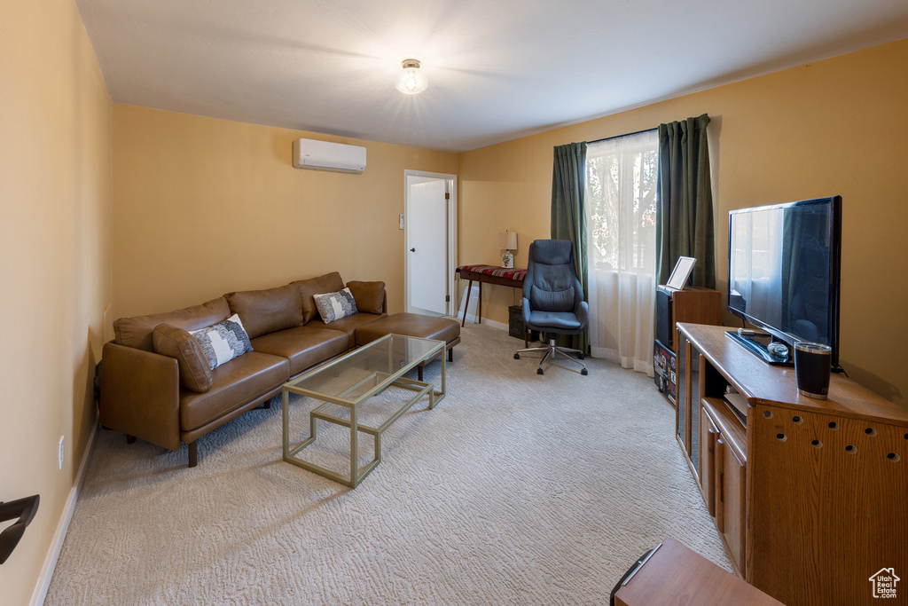 Living room with a wall unit AC, light colored carpet, and baseboards