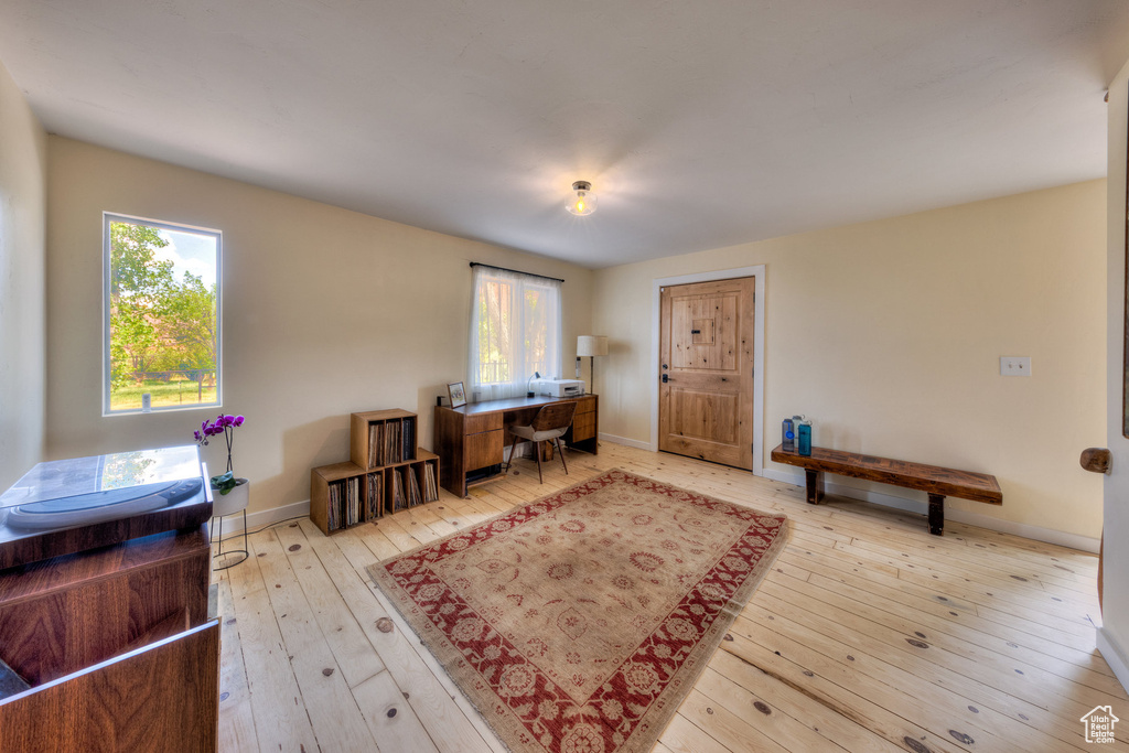 Office with wood-type flooring and baseboards