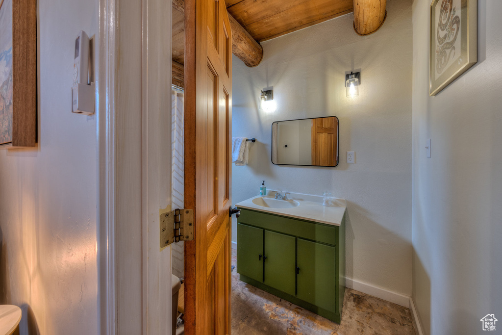 Bathroom featuring vanity and baseboards