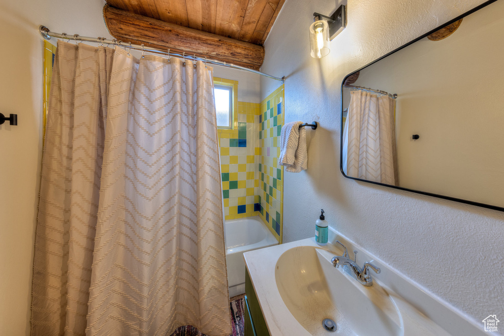 Full bathroom featuring wooden ceiling, shower / tub combo, and vanity