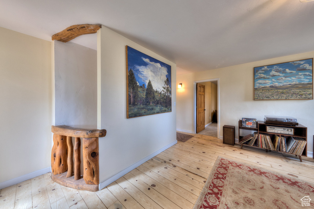 Corridor featuring hardwood / wood-style flooring and baseboards