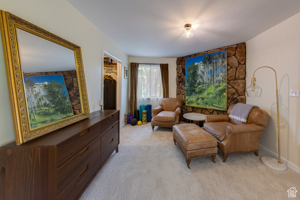 Living area with light colored carpet and baseboards