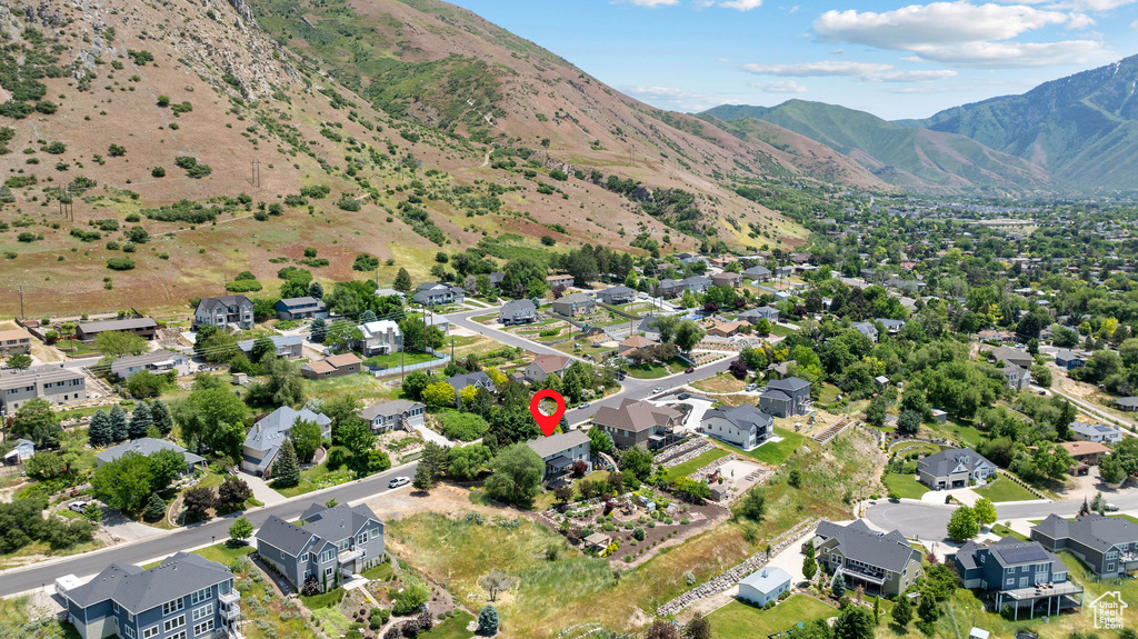Aerial view of property's location featuring mountains and nearby suburban area