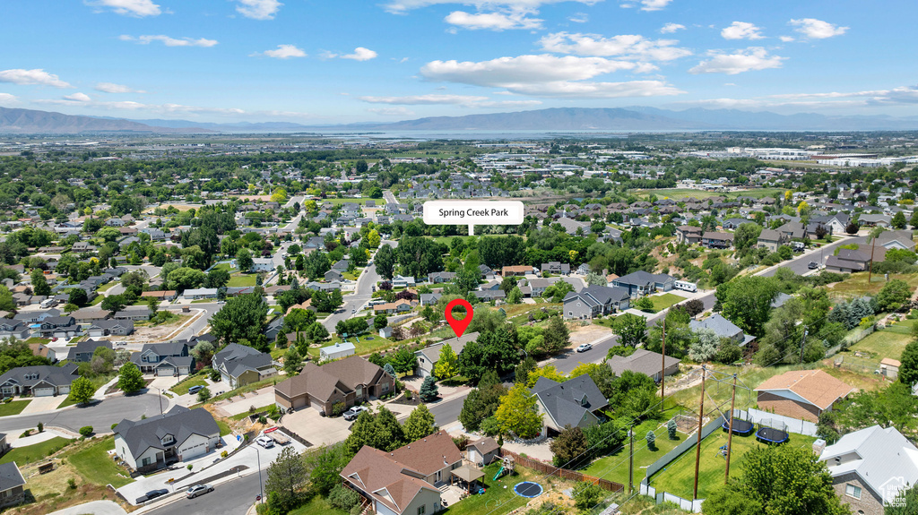 Aerial view of property's location featuring a mountainous background and nearby suburban area