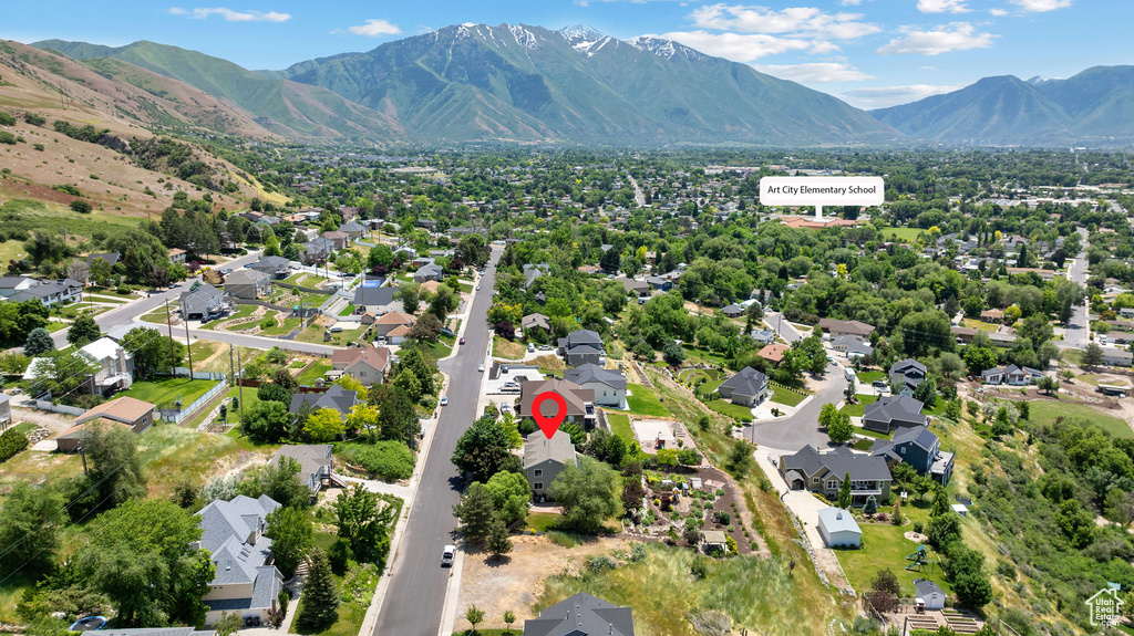 Aerial perspective of suburban area featuring a mountain backdrop