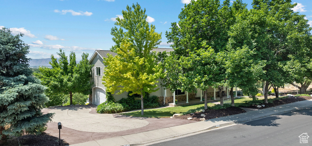 Obstructed view of property with driveway and an attached garage