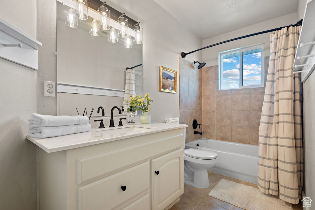 Full bath featuring vanity, shower / bath combo, tile patterned floors, and toilet