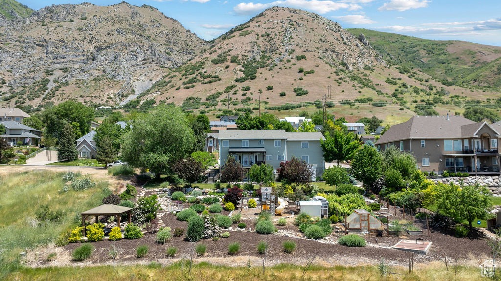View of mountain backdrop featuring nearby suburban area