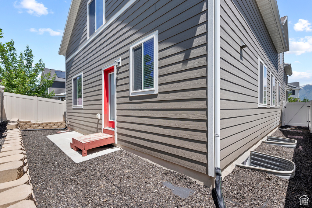 View of property exterior featuring a fenced backyard and a gate
