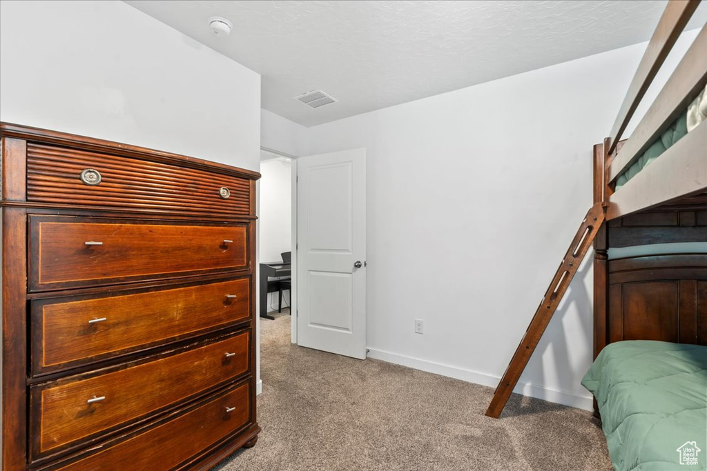 Carpeted bedroom featuring baseboards