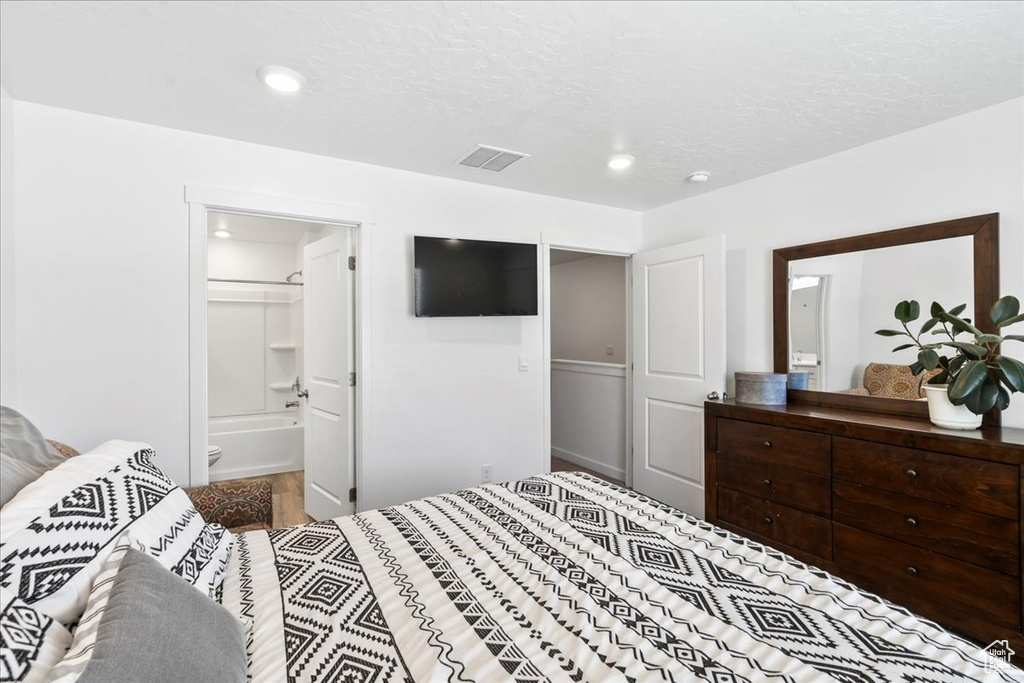Bedroom with recessed lighting and ensuite bathroom