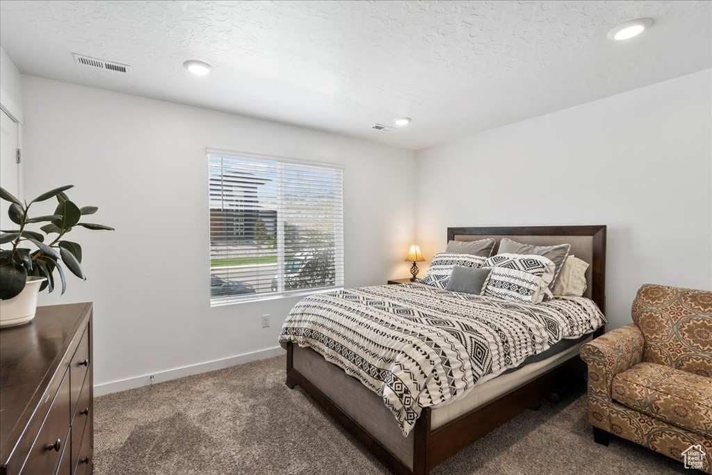 Carpeted bedroom featuring baseboards and recessed lighting
