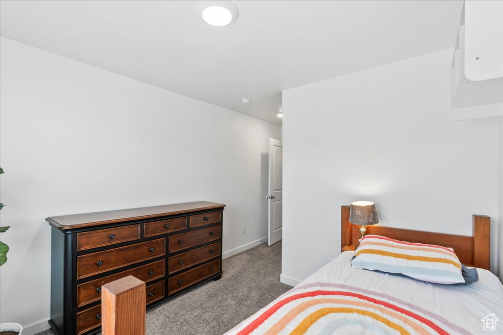 Carpeted bedroom featuring baseboards