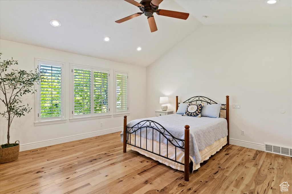 Bedroom featuring recessed lighting, vaulted ceiling, baseboards, light wood-style floors, and a ceiling fan
