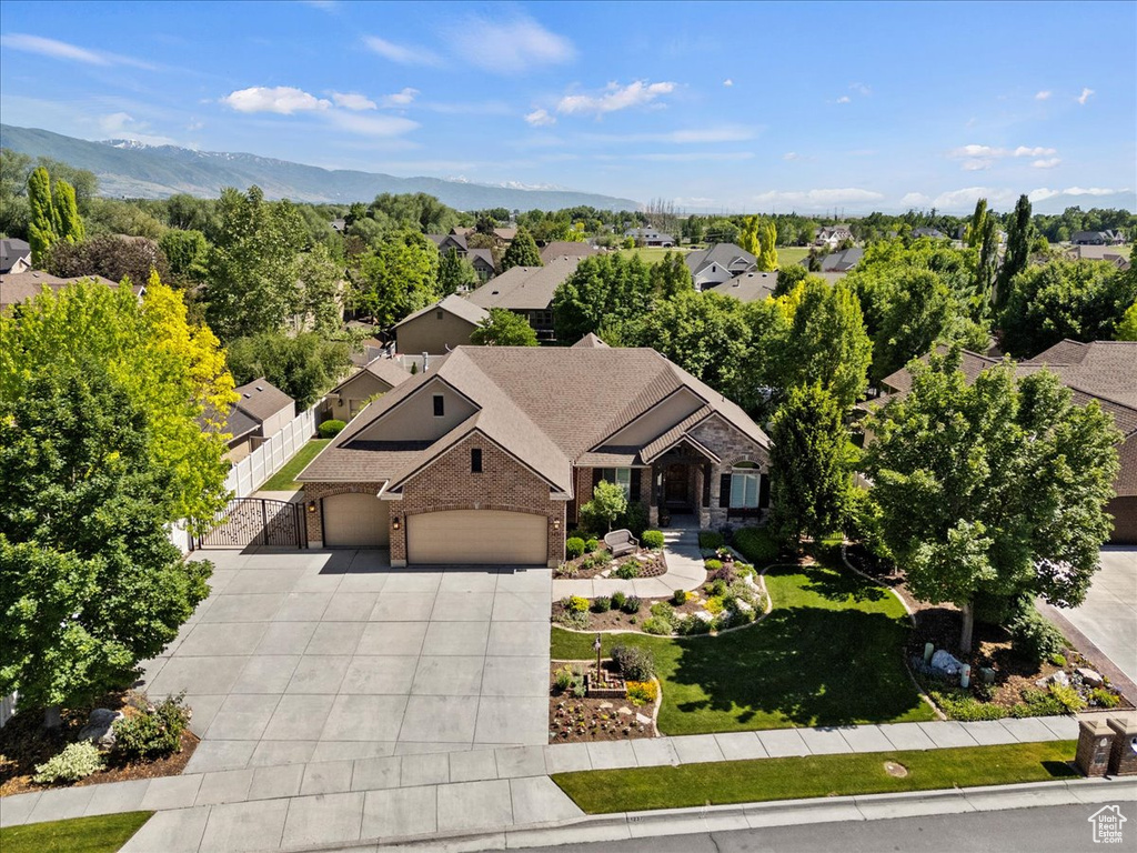 Aerial view of property and surrounding area with a mountain backdrop
