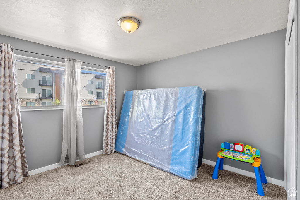 Unfurnished bedroom featuring carpet floors and baseboards