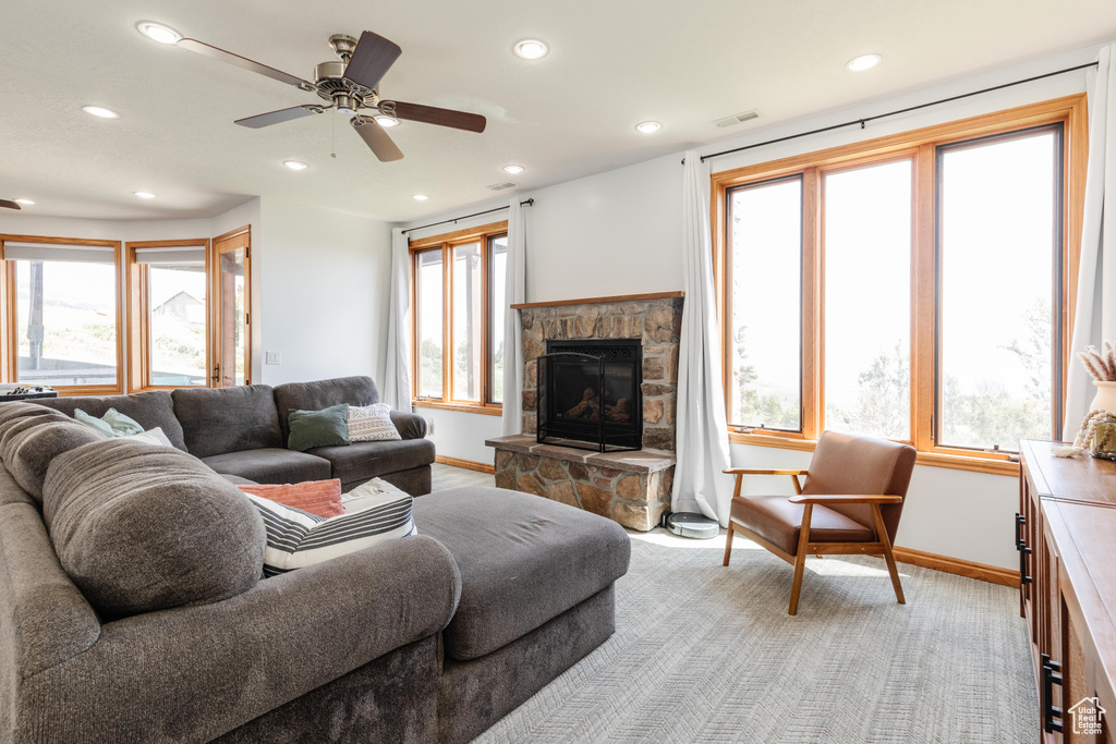 Living area featuring a fireplace, plenty of natural light, baseboards, recessed lighting, and a ceiling fan