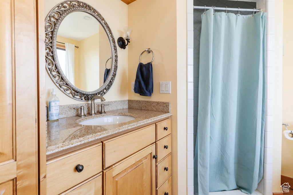 Full bathroom featuring vanity and a shower with shower curtain