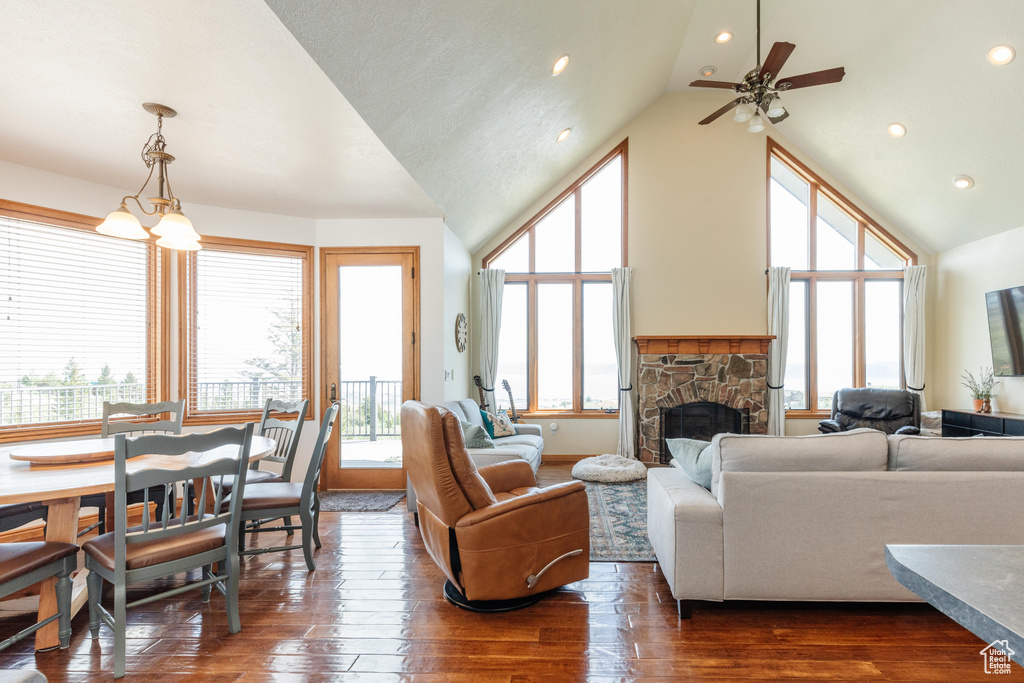 Living room featuring a fireplace, dark wood-style floors, a ceiling fan, recessed lighting, and high vaulted ceiling
