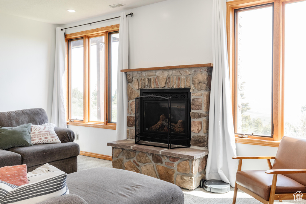 Living room featuring healthy amount of natural light, baseboards, and a fireplace