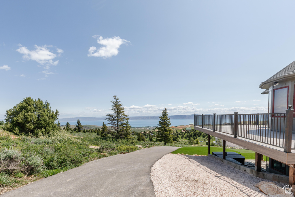 Surrounding community featuring a deck with water view