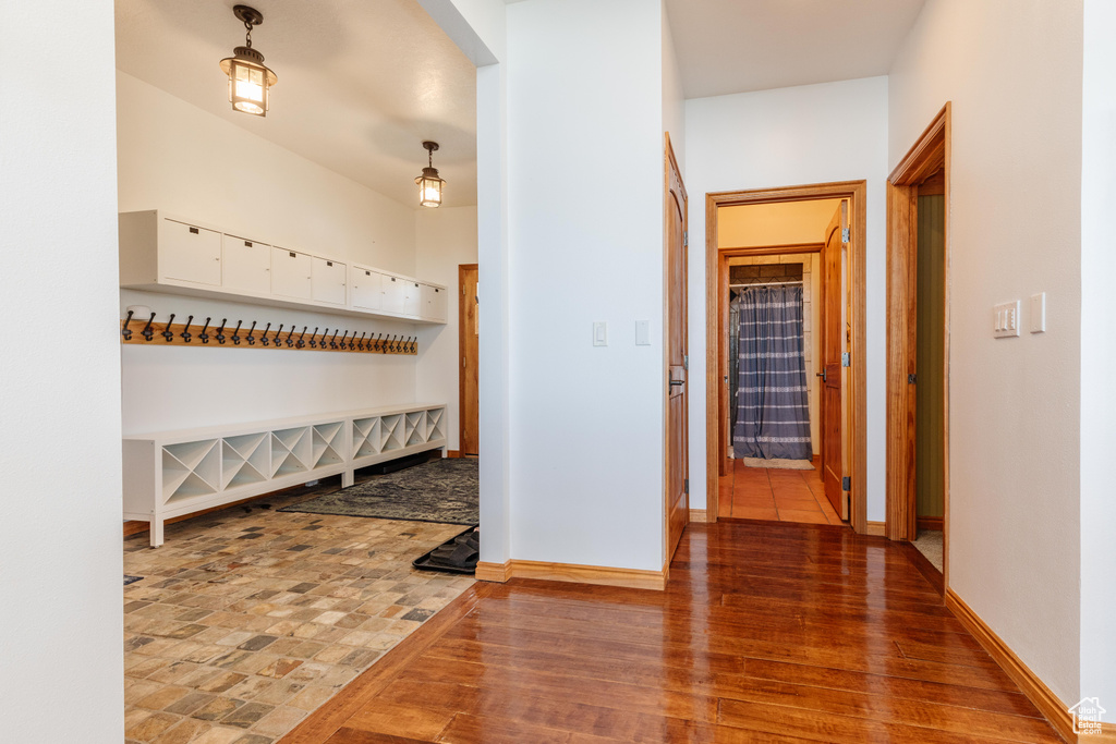 Hall with baseboards and wood finished floors
