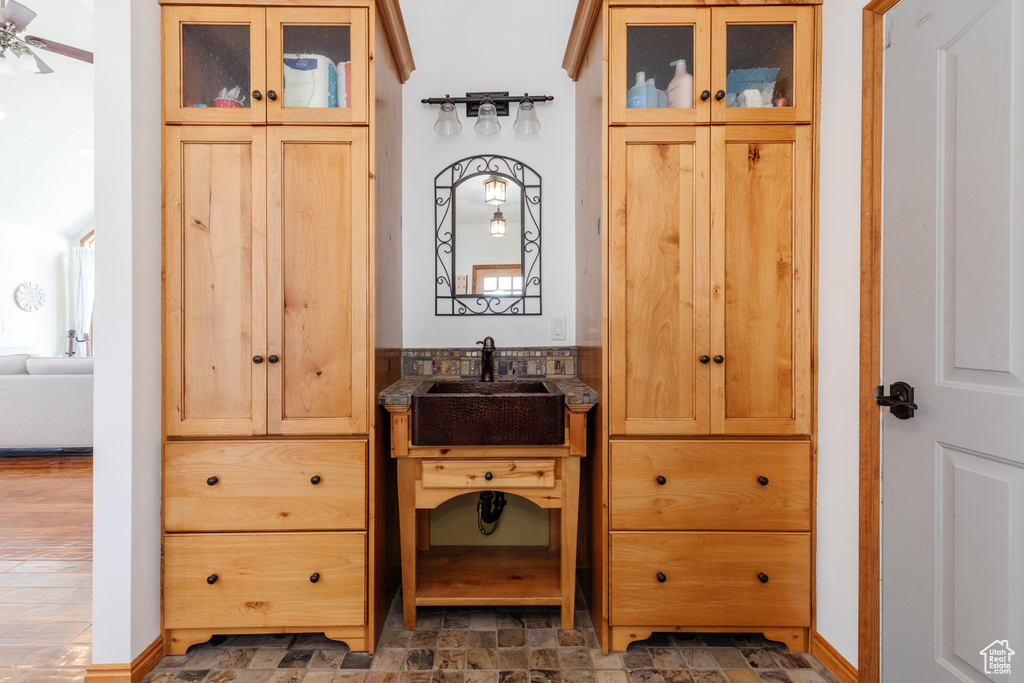Interior space with vanity and stone finish flooring