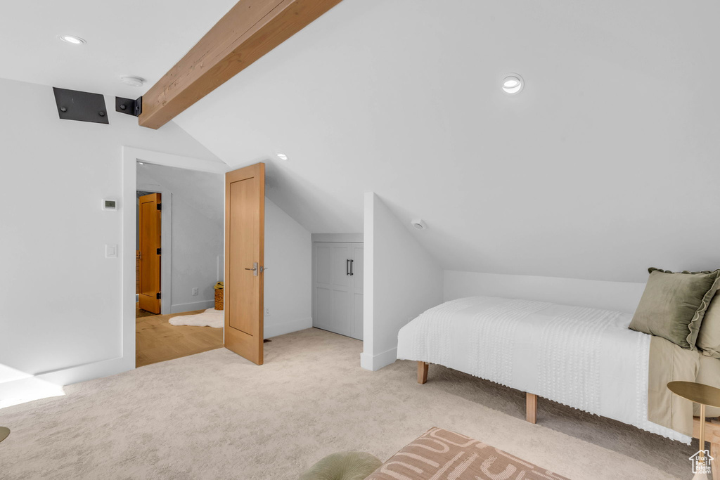 Bedroom with light colored carpet and recessed lighting