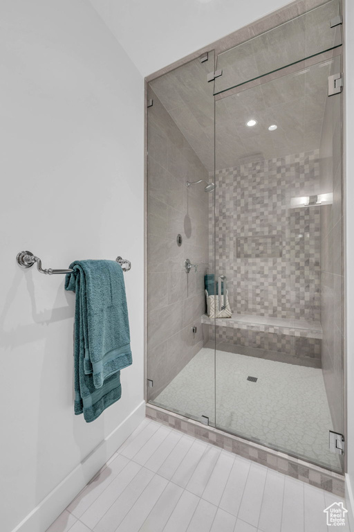 Bathroom with a shower stall and baseboards