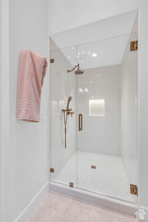 Bathroom with a stall shower, baseboards, tile patterned floors, and recessed lighting