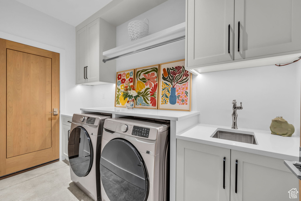 Laundry area featuring washer and dryer and cabinet space