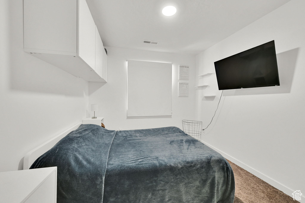Carpeted bedroom featuring baseboards