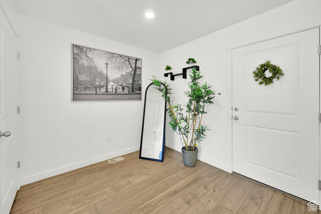 Foyer entrance featuring light wood-style floors, baseboards, and recessed lighting