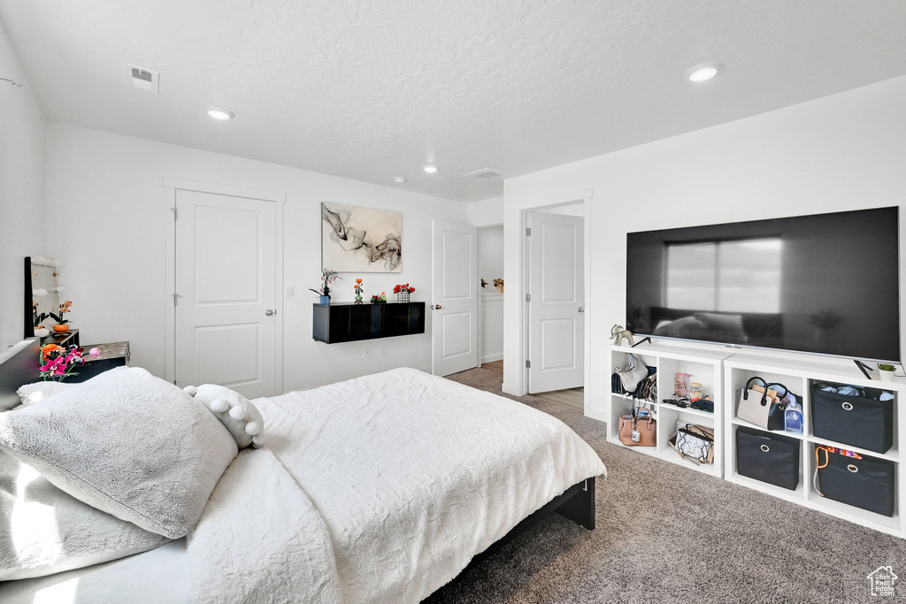 Carpeted bedroom with recessed lighting
