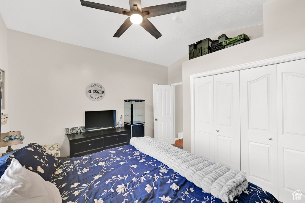 Bedroom featuring a closet, ceiling fan, and lofted ceiling