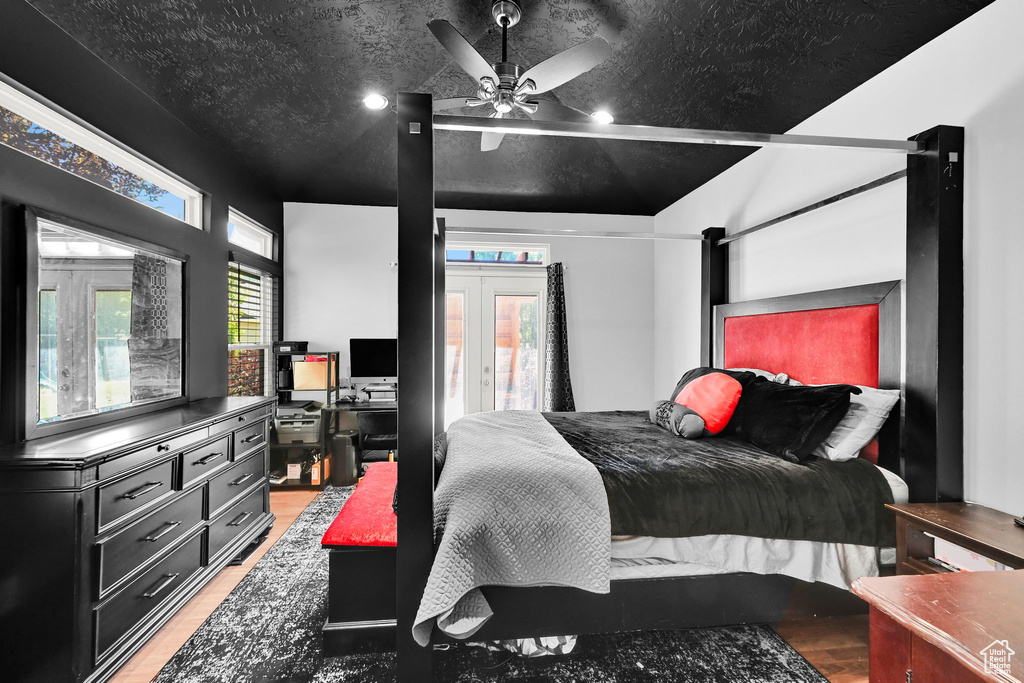 Bedroom featuring light wood-type flooring, french doors, and an office area