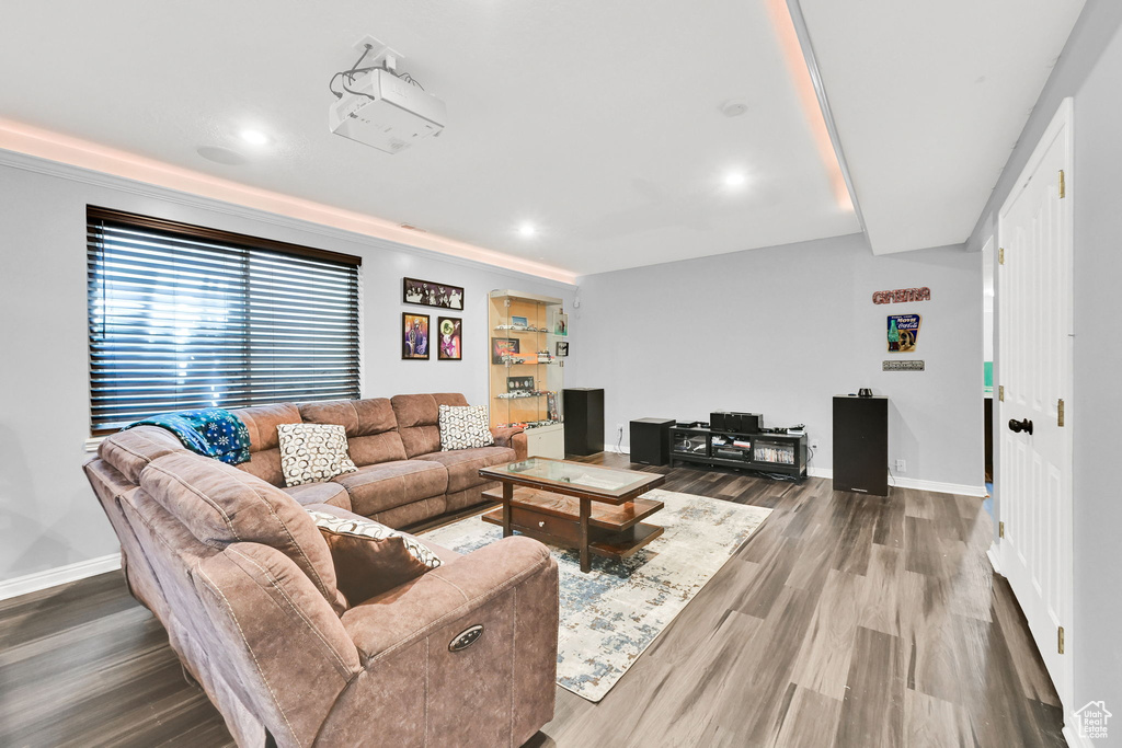 Living room with wood finished floors, baseboards, and recessed lighting