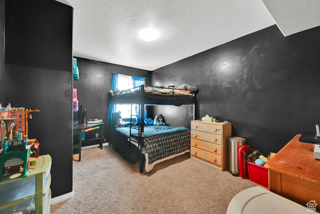 Carpeted bedroom featuring a textured ceiling