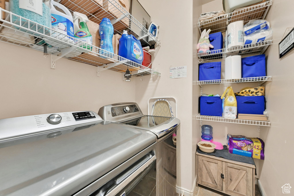 Laundry room featuring separate washer and dryer and baseboards