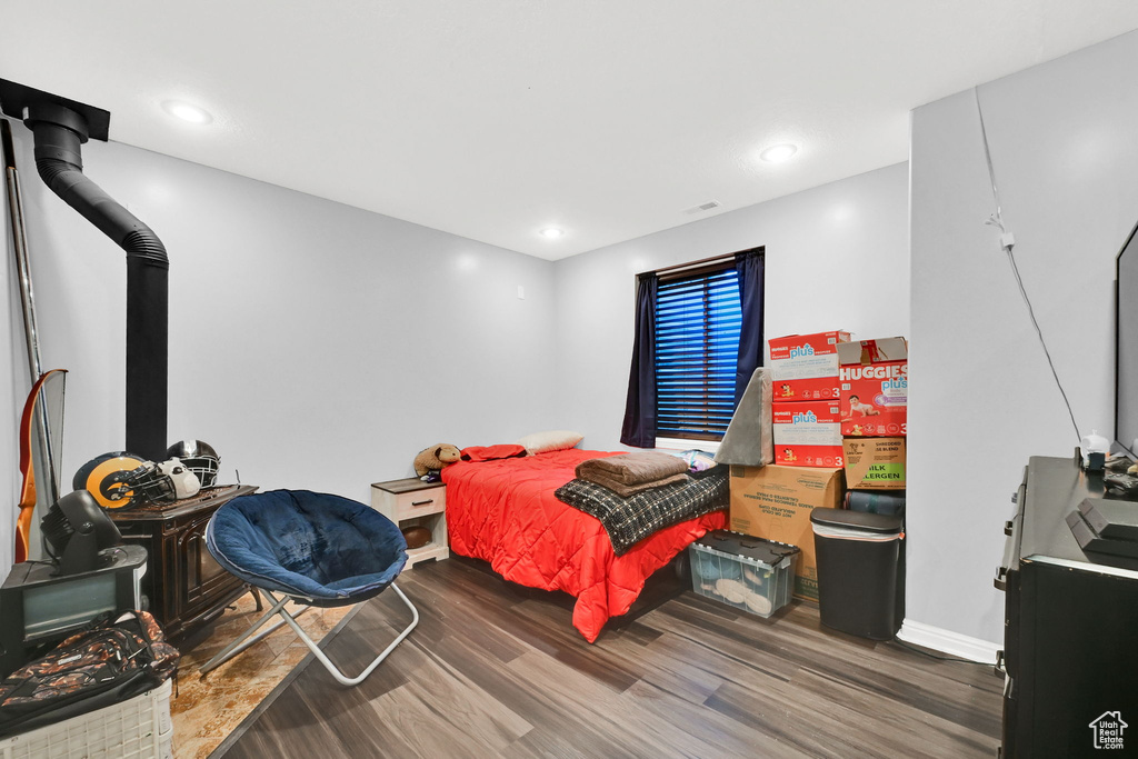 Bedroom with wood finished floors and baseboards