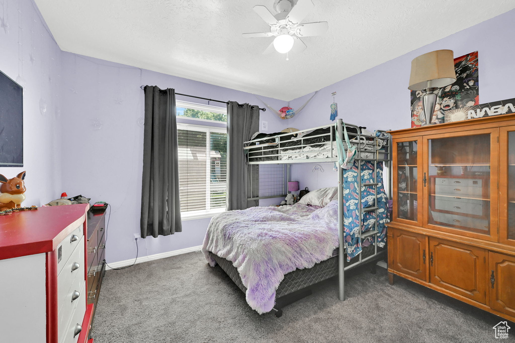 Bedroom with carpet floors, a textured ceiling, ceiling fan, and baseboards