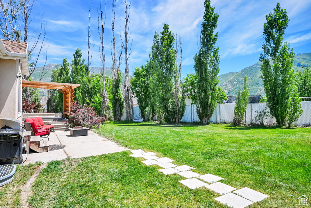 View of yard with a mountain view and a patio